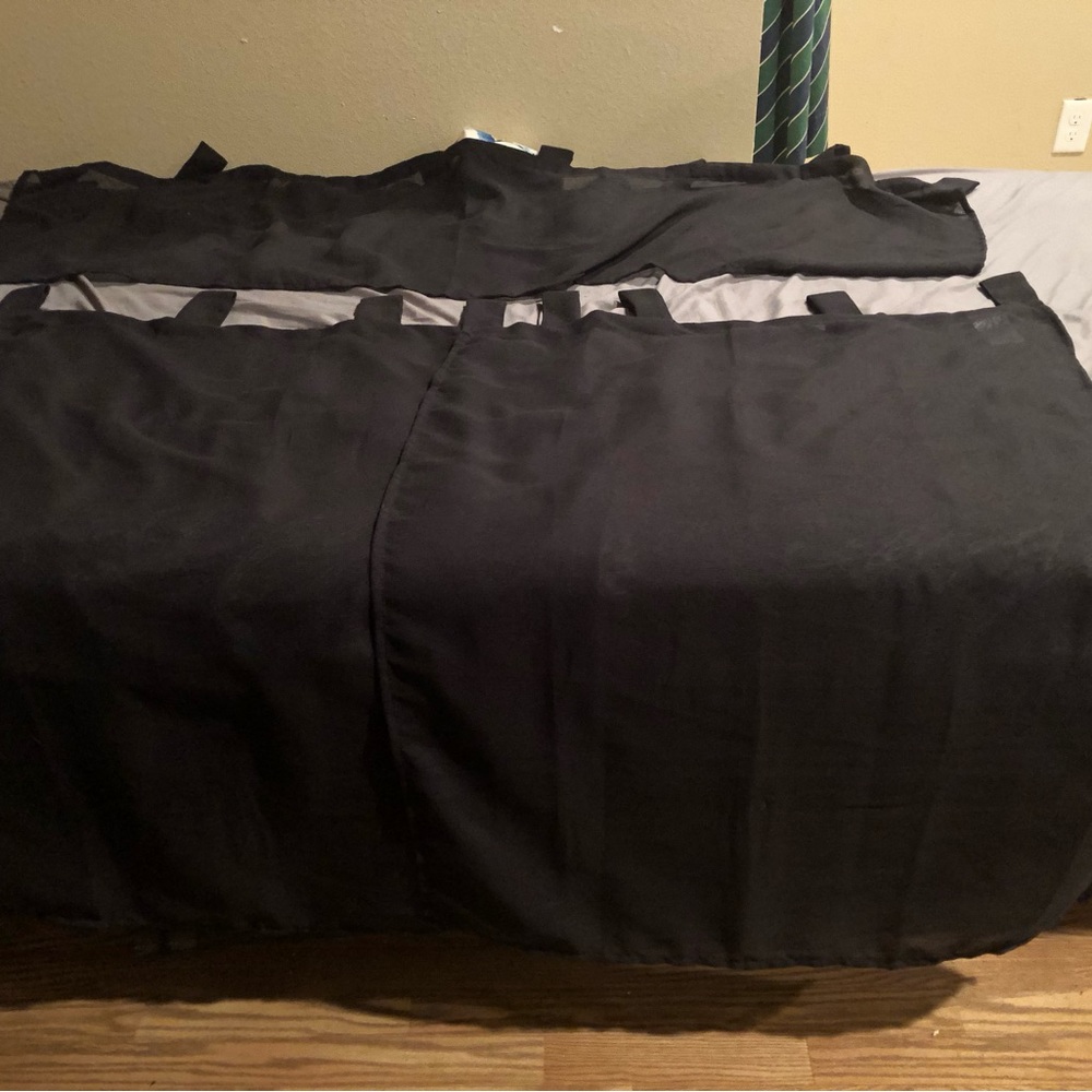 Two 28” x 36” sheer curtains with a 56” x 14” sheer valance in black￼